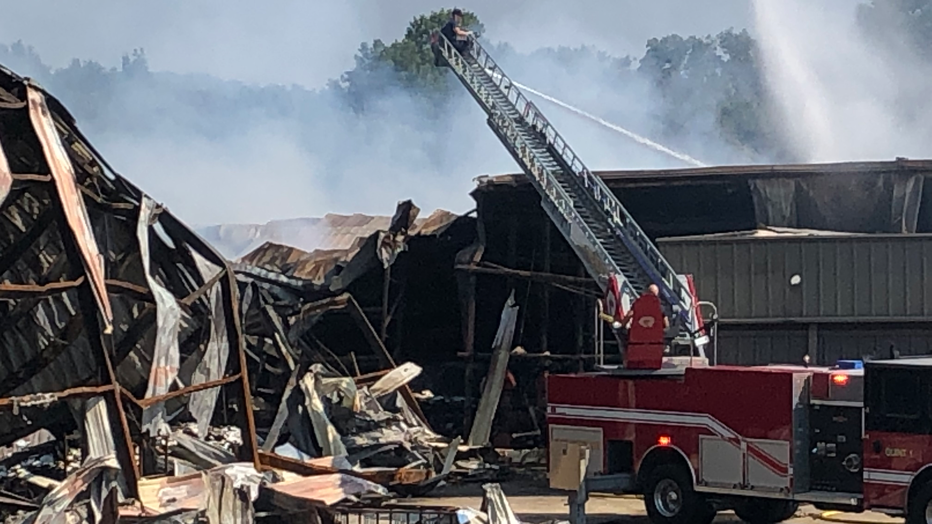 Firefighters continue Wednesday to douse the massive blaze at an Attalla, AL, paper products warehouse.
