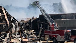 Firefighters continue Wednesday to douse the massive blaze at an Attalla, AL, paper products warehouse.