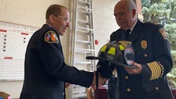 Retiring Barrington, IL, firefighter John Matlachwski receives a commemorative helmet from Chief Jim Arie during a ceremony Sept. 13.