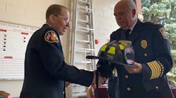 Retiring Barrington, IL, firefighter John Matlachwski receives a commemorative helmet from Chief Jim Arie during a ceremony Sept. 13. Retiring Barrington, IL, firefighter John Matlachwski receives a commemorative helmet from Chief Jim Arie during a ceremony Sept. 13.