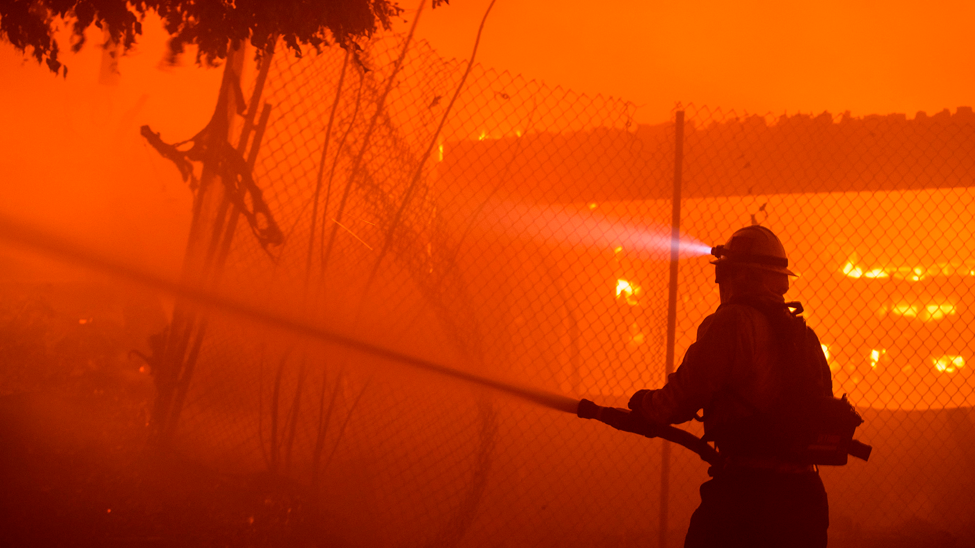 Firefighters work the Getty fire as it burns homes along Tigertail Road in the Brentwood Heights neighborhood of Los Angeles on Monday.