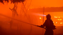 Firefighters work the Getty fire as it burns homes along Tigertail Road in the Brentwood Heights neighborhood of Los Angeles on Monday.