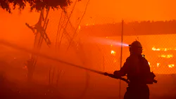 Firefighters work the Getty fire as it burns homes along Tigertail Road in the Brentwood Heights neighborhood of Los Angeles on Monday.
