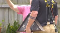 A Houston firefighter retrieved an encased U.S. burial flag from the ash and rubble of a condo fire Tuesday. A Houston firefighter retrieved an encased U.S. burial flag from the ash and rubble of a condo fire Tuesday.