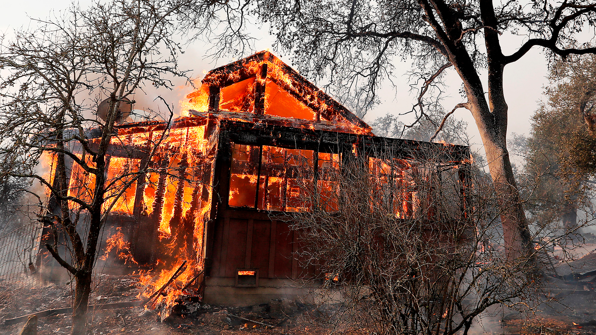 A house along State Highway 128 near Healdsburg, CA, is engulfed in flames by the Kincade fire on Sunday.
