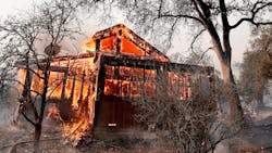 A house along State Highway 128 near Healdsburg, CA, is engulfed in flames by the Kincade fire on Sunday.