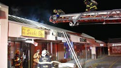 Palmer, PA, firefighters stopped flames from spreading to a nearby store after a malfunctioning neon sign sparked a two-alarm fire on the roof of a Chinese restaurant early Thursday.