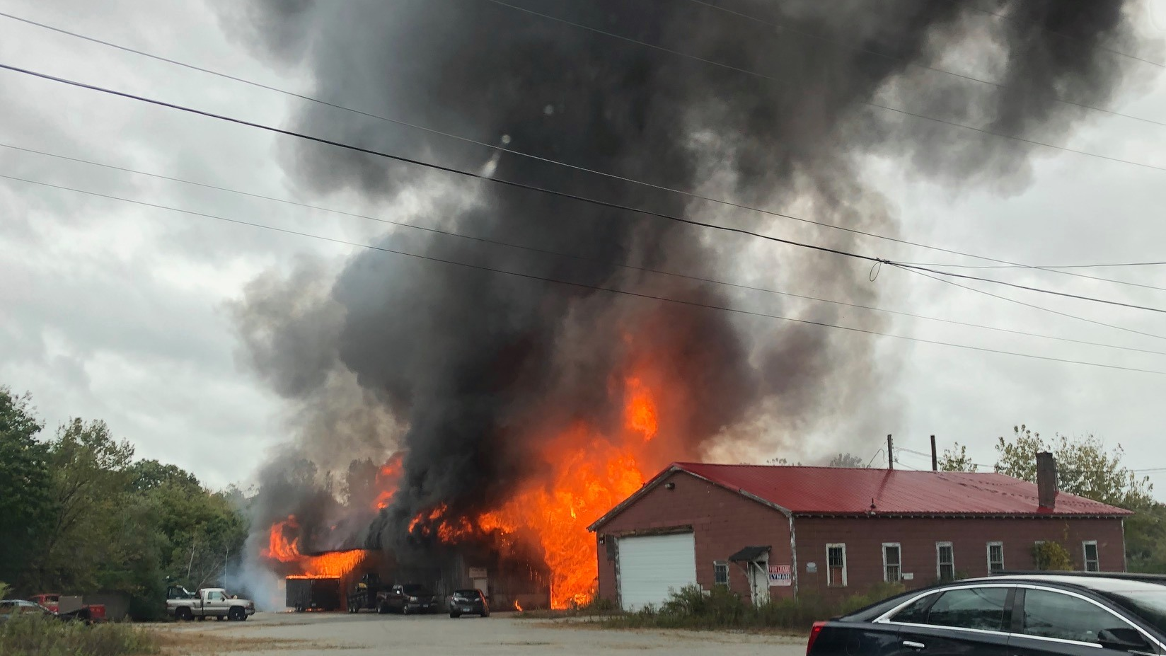 Firefighters from multiple departments battled a large blaze at an auto storage warehouse Sunday in Plainfield, CT.