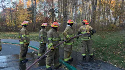 Students in a firefighting class at Quaboag Regional High School in Warren, MA, wear turnout gear and learn to use a fire hose.