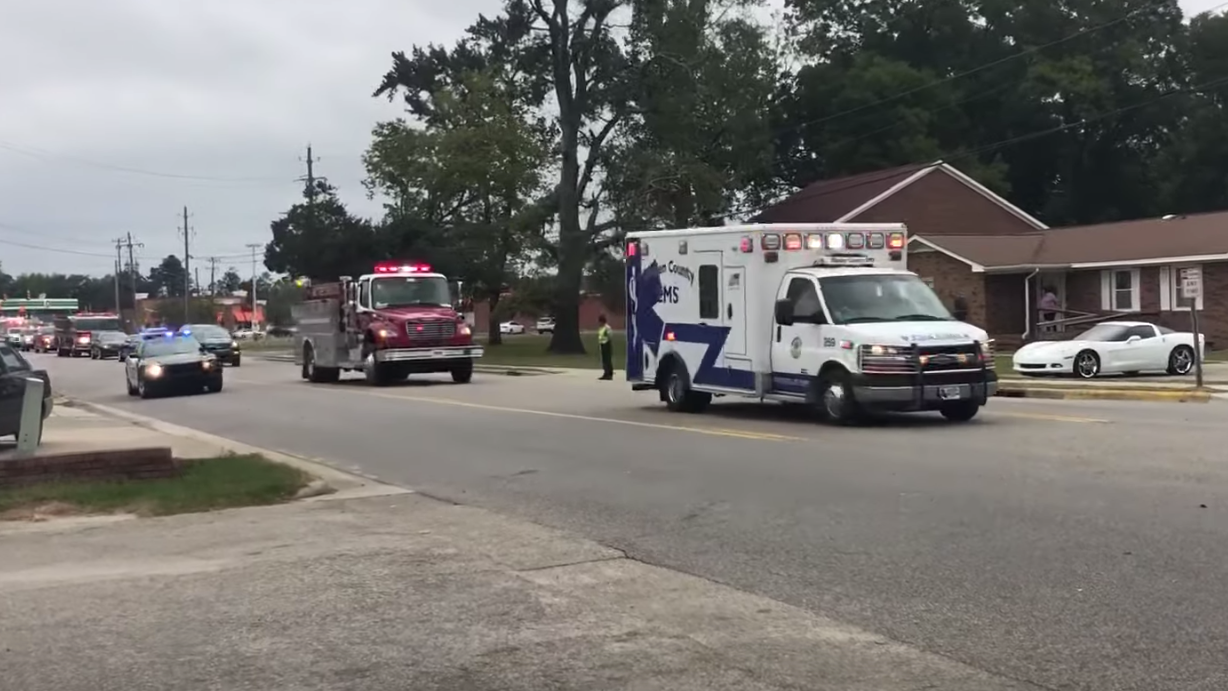 First responders escort the body of White Lake, NC, firefighter Mildred Gray Williams, who died in a construction accident Tuesday.