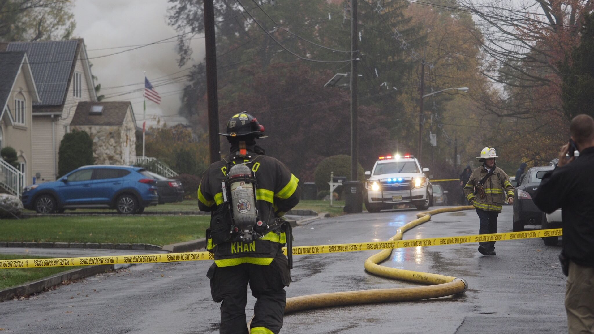 Firefighters respond to a fire caused by a twin-engine plane crash into a residential area in Woodbridge, NJ, on Tuesday.