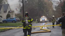Firefighters respond to a fire caused by a twin-engine plane crash into a residential area in Woodbridge, NJ, on Tuesday.