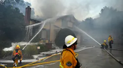 Orange County firefighters work to knock down a house fire on Singing Hills Drive as the Saddleridge Fire burns on Oct. 11, 2019, in Porter Ranch, CA. Orange County firefighters work to knock down a house fire on Singing Hills Drive as the Saddleridge Fire burns on Oct. 11, 2019, in Porter Ranch, CA.