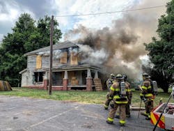 During live-fire training, the Salisbury, NC, Fire Department (SFD) appeared to have a close call. As the fire on the second floor intensified, a large piece of burning plywood flew from a window, narrowly missing a firefighter positioned at the bottom of a ladder. During live-fire training, the Salisbury, NC, Fire Department (SFD) appeared to have a close call. As the fire on the second floor intensified, a large piece of burning plywood flew from a window, narrowly missing a firefighter positioned at the bottom of a ladder.