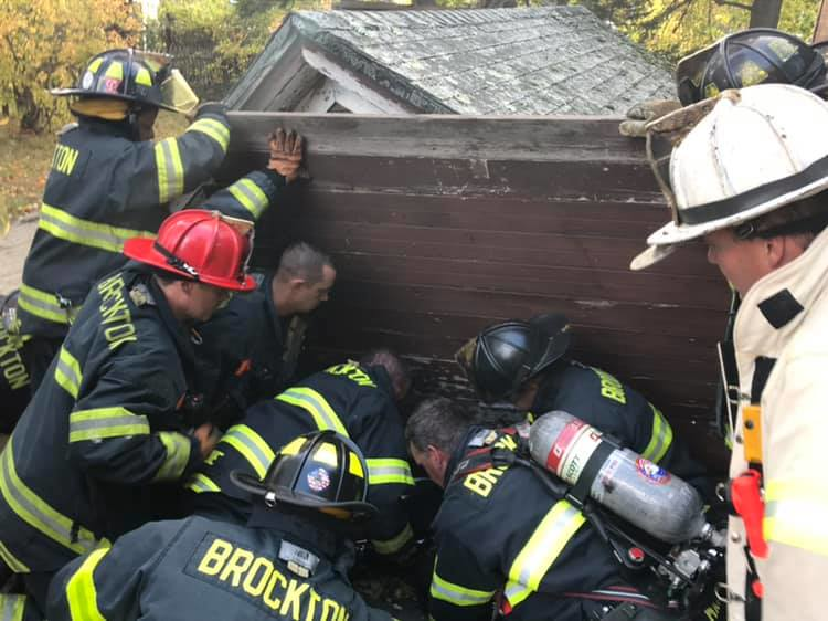 Brockton, MA, firefighters extricated two men Friday who were trapped when the roof of the shed they were in collapsed on them.