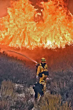 SANTA CLARITA, CA, OCT. 24—The Tick Canyon fire, which started just off Highway 14 in Santa Clarita (20 miles northwest of Los Angeles), was fought by units from the Los Angeles County Fire Department and the Angeles National Forest Service, among others. At last report, the fire burned 4,615 acres and destroyed 29 structures and damaged an additional 40 homes as well as two commercial buildings. Los Angeles County firefighters assigned to Engine 74 worked to knock down flames in brush near an apartment complex. Numerous aircraft were deployed, including a CAL FIRE twin-engine S-2 during the early stages of the fire.