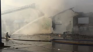 Two Alpena, MI, firefighters were injured while battling a blaze at a Habitat for Humanity ReStore building Sunday.