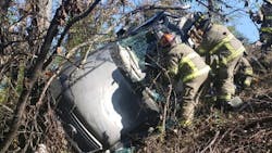 Two women and an infant were extricated from a vehicle that flipped off Interstate 65 in Birmingham on Tuesday.