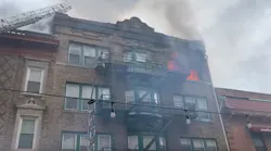 A firefighter and police officer were injured responding to a three-alarm apartment blaze Thursday in Bloomfield, NJ.