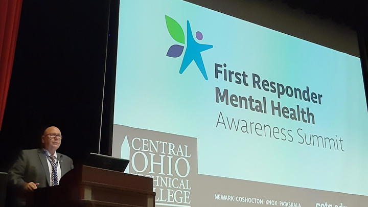 Kevin Reardon, a former firefighter with the Columbus, OH, Division of Fire and director of Central Ohio Technical College's Institute for Public Safety in Newark, welcomes about 130 attendees Wednesday to the First Responder Mental Health Awareness Summit, where sessions addressed the traumas suffered by first responders.