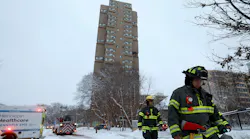 Minneapolis firefighters leave the scene of a deadly fire at a high-rise apartment building early Wednesday.