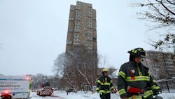 Minneapolis firefighters leave the scene of a deadly fire at a high-rise apartment building early Wednesday.