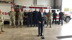 Connecticut Gov. Ned Lamont (center) thanks firefighters Wednesday for their response during the Oct. 2 crash of a World War II-era airplane at Bradley International Airport.