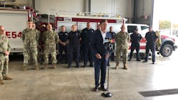 Connecticut Gov. Ned Lamont (center) thanks firefighters Wednesday for their response during the Oct. 2 crash of a World War II-era airplane at Bradley International Airport.
