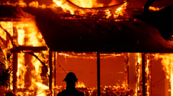 A firefighter watches the tasting room of the Soda Rock Winery be consumed by flames from the Kincade wildfire Oct. 27.