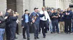 FDNY EMT Liam Gilnane (center) leaves Mount Sinai Hospital in New York City on Wednesday with EMS Lt. Raymond Wang (left).