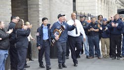 FDNY EMT Liam Gilnane (center) leaves Mount Sinai Hospital in New York City on Wednesday with EMS Lt. Raymond Wang (left).