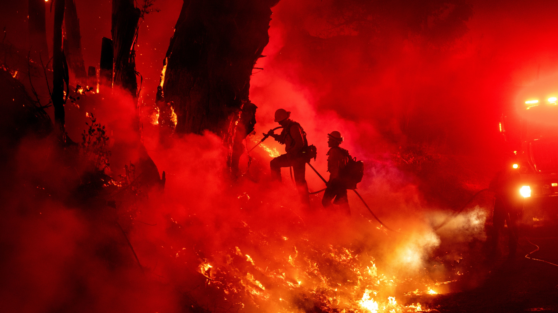 Firefighters work to control flames Friday from a backfire during the Maria fire in Santa Paula, CA.