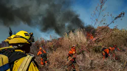 Inmate firefighters clear brush as they work Friday to slow down the spread of the Maria fire on the Santa Clara river bed in Santa Paula, CA.