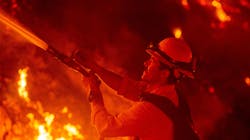 A firefighter douses flames from a backfire during the Maria fire Thursday in Santa Paula, CA.