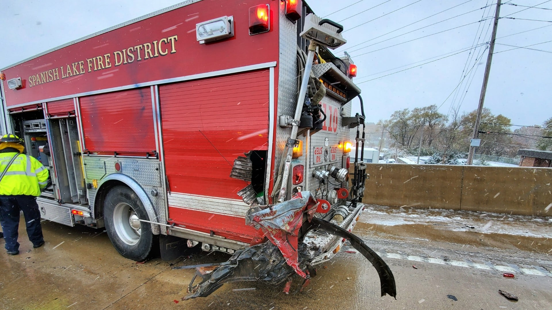 A Spanish Lake, MO, firefighter responding to a two-car crash Monday was injured after a pickup truck reportedly lost control on the icy road and hit the first responder's apparatus.