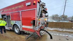 A Spanish Lake, MO, firefighter responding to a two-car crash Monday was injured after a pickup truck reportedly lost control on the icy road and hit the first responder&apos;s apparatus.