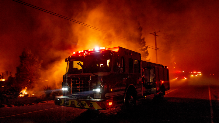 A fire engine drives past the Soda Rock Winery in Healdsburg, CA, during the Kincade Fire on Oct. 27, 2019.