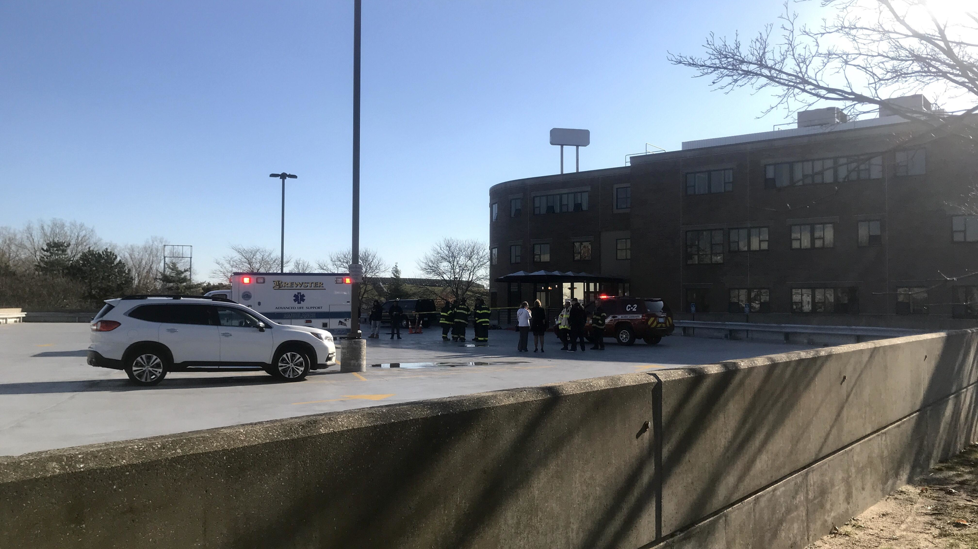 Officials stand outside the Harvard Vanguard Medical Associates building in Braintree, MA, after a chemical spill hospitalized seven people on Wednesday, Nov. 6, 2019.
