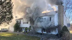 North Branford firefighters battle a house fire where a woman was removed after being trapped in the basement.