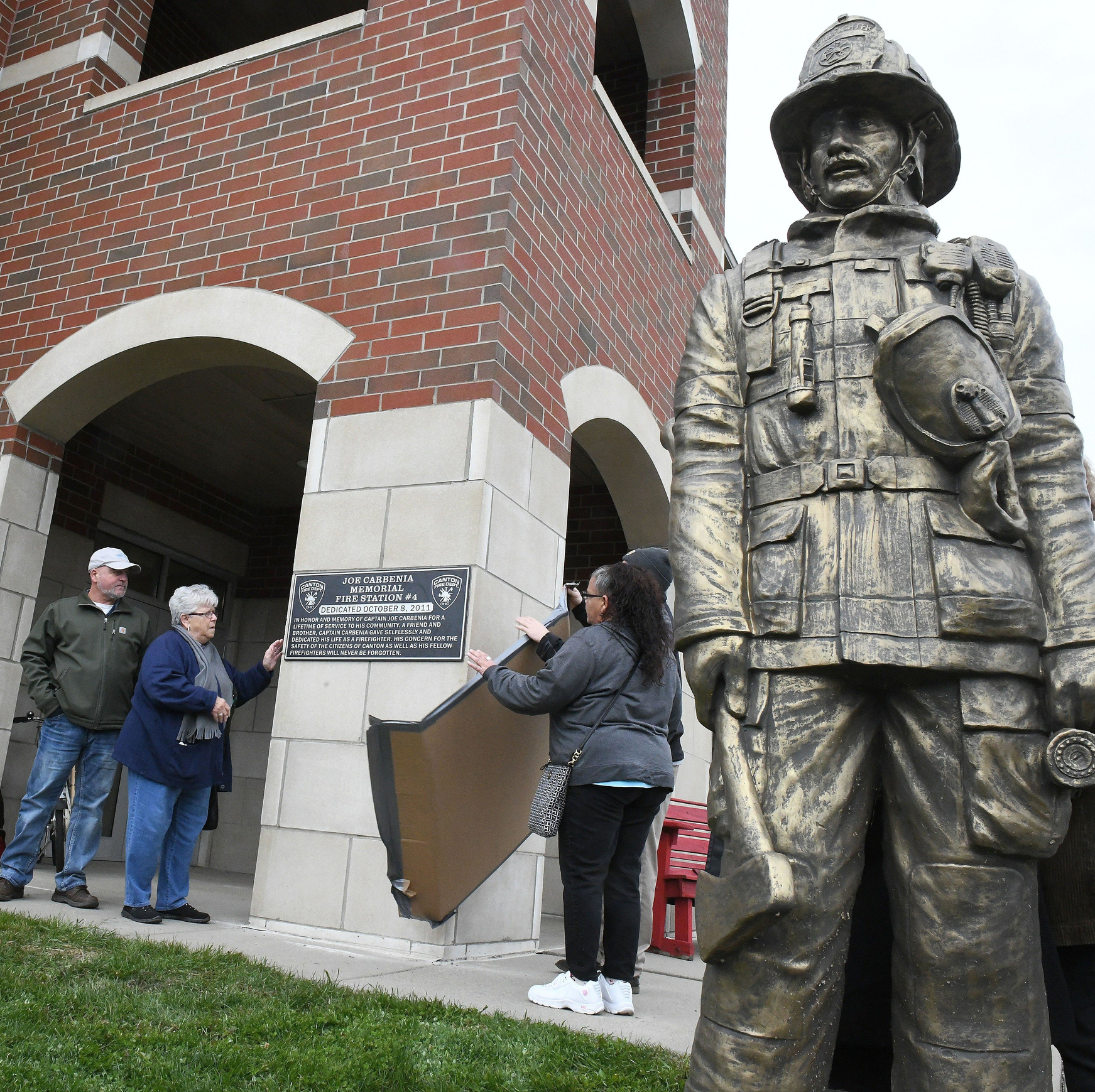 The Carbenia family unveils a plaque to memorialize Canton, OH, fire station No. 4 in honor of Joe Carbenia.
