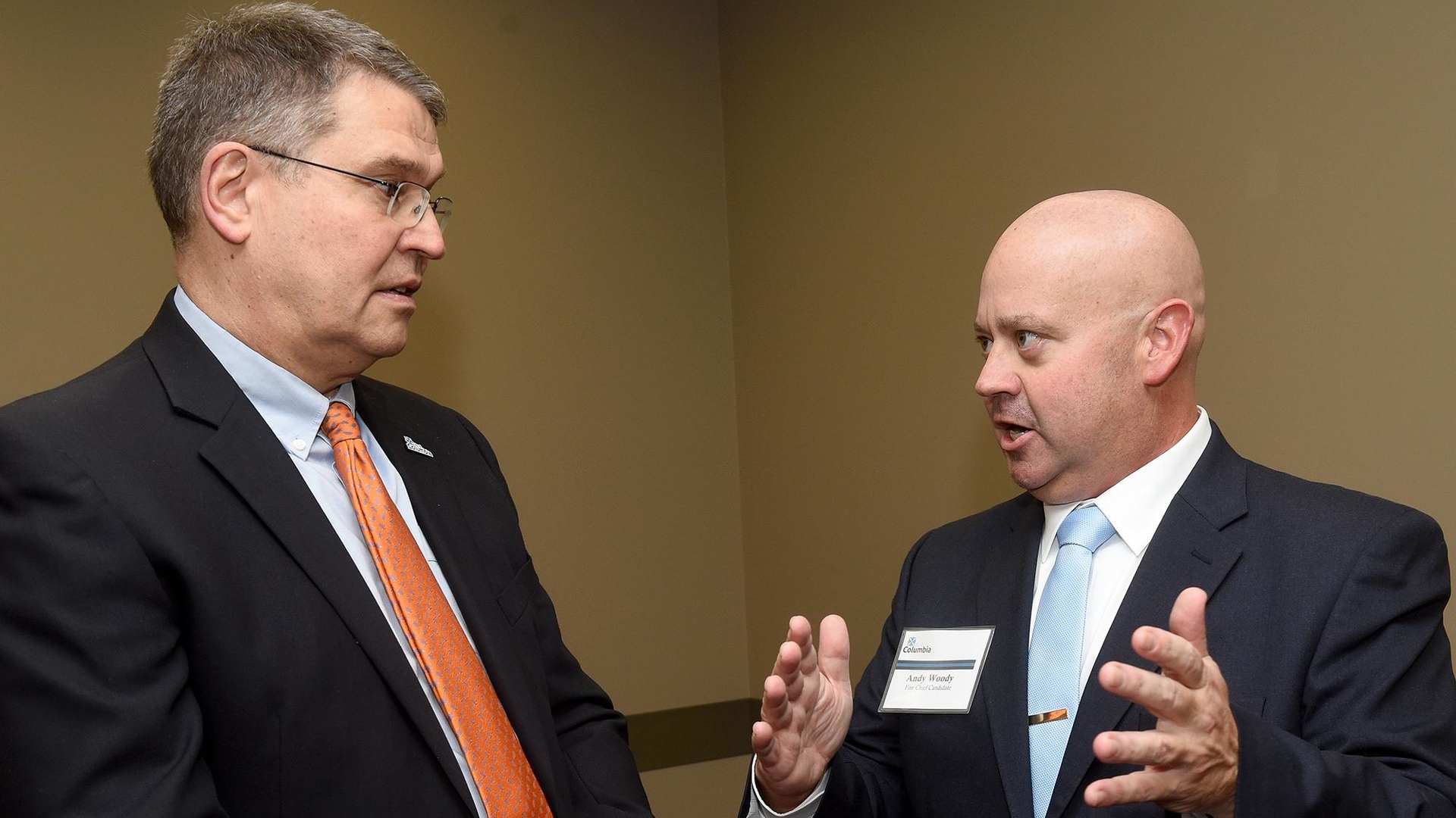 New Columbia, MO, Fire Chief Andy Woody (right) speaks to Tim Teddy, Columbia director of community development, during a public meet-and-greet event for the three chief finalists.