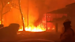 Dramatic video from an Australian firefighter shows flames from a brushfire threatening homes Blackheath valley Saturday.
