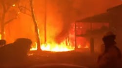 Dramatic video from an Australian firefighter shows flames from a brushfire threatening homes Blackheath valley Saturday.