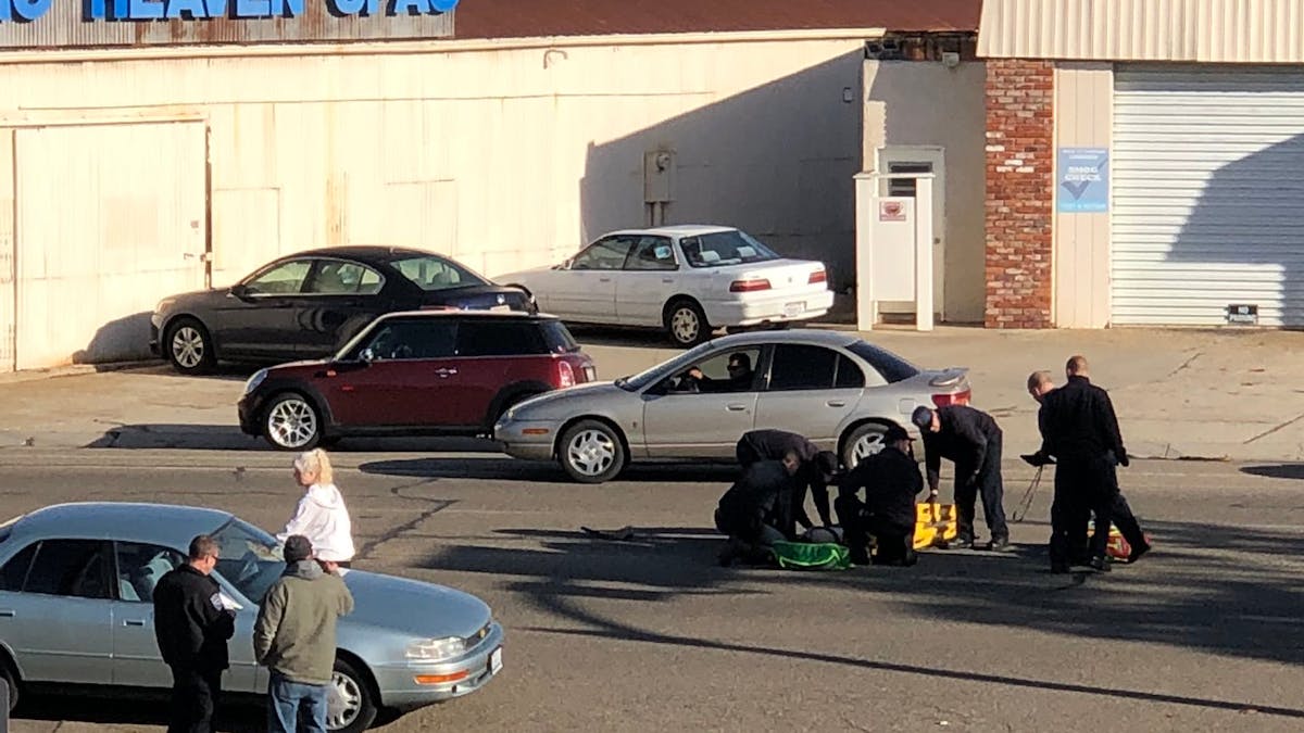 Five Cities, CA, firefighters treat an injured woman who was struck by a car in front of the fire station Friday.