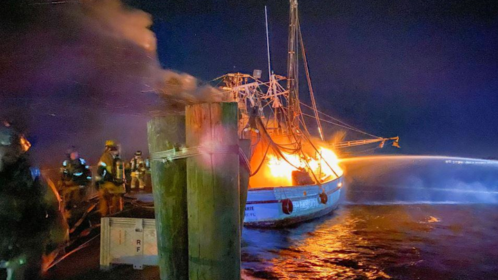 Fire engulfs one of the Mayport shrimp boats as Jacksonville, FL, firefighters battle the blaze.