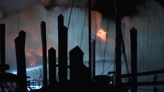 Firefighters battle a massive fire that broke out on two yachts docked at the Seaview Harbor Marina in Egg Harbor Township, NJ, early Monday.