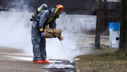 Muskegon Heights, MI, firefighters worked to clean up 90 gallons of sulfuric acid that leaked onto the ground after a bulk transport container fell from a forklift Monday. Muskegon Heights, MI, firefighters worked to clean up 90 gallons of sulfuric acid that leaked onto the ground after a bulk transport container fell from a forklift Monday.