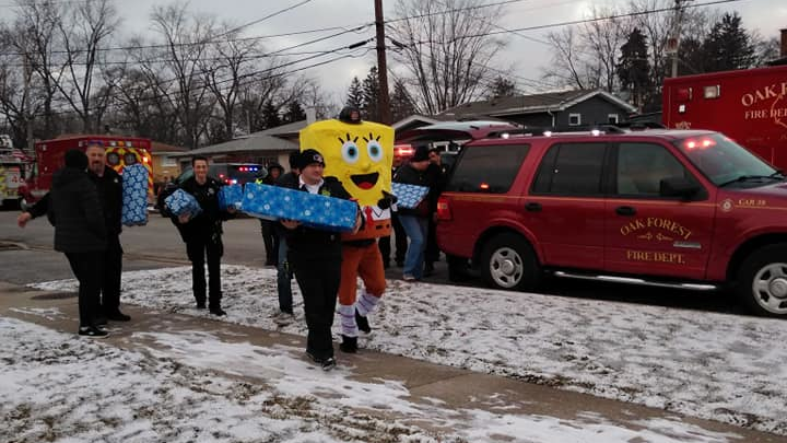 Oak Forest, IL, firefighters deliver Christmas gifts to kids with cancer as part of Project Fire Buddies.