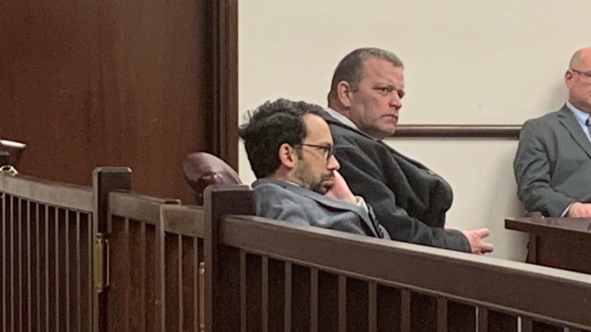 Former Utica, NY, firefighter Richard Forte (right) listens at his sentencing at Utica City Court on Monday.