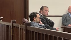 Former Utica, NY, firefighter Richard Forte (right) listens at his sentencing at Utica City Court on Monday.